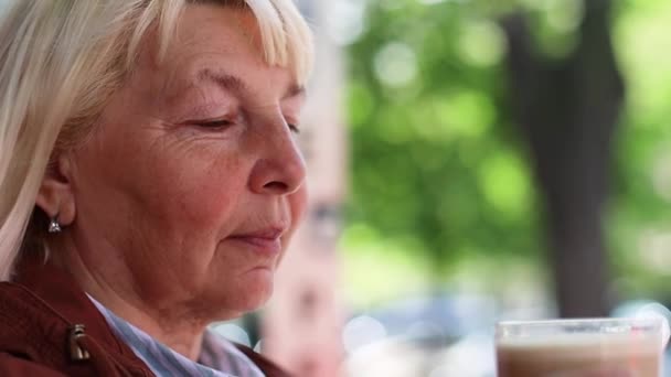 Glückliche blonde Frau genießt es, morgens im Café Aroma-Kaffee mit Milch zu trinken. - Filmmaterial, Video