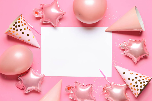 Composition with sheet of paper, balloons and party hats on color background - Photo, Image