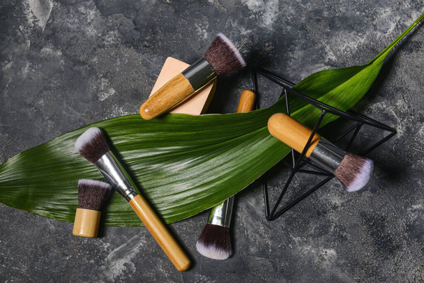 Set of makeup brushes with decor on grunge background - Photo, Image