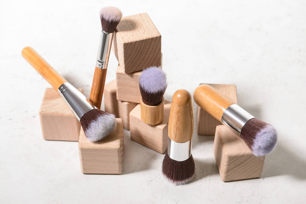 Set of makeup brushes with decor on white background - Photo, Image