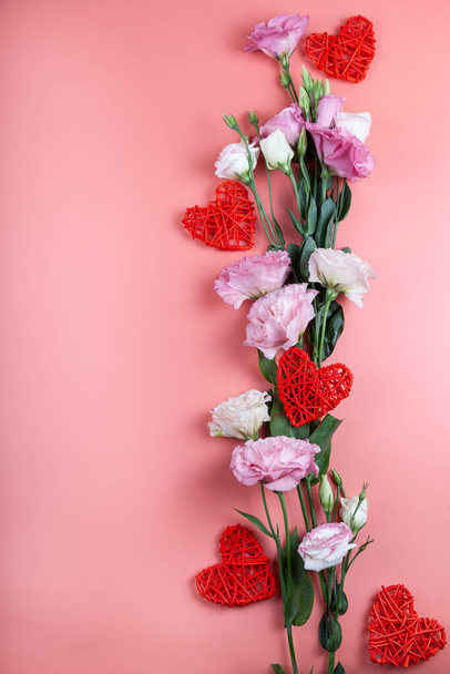 Bouquet of flowers and hearts on a pink abackground. Beautiful eustomas. Valentines day card. - Foto, Imagem