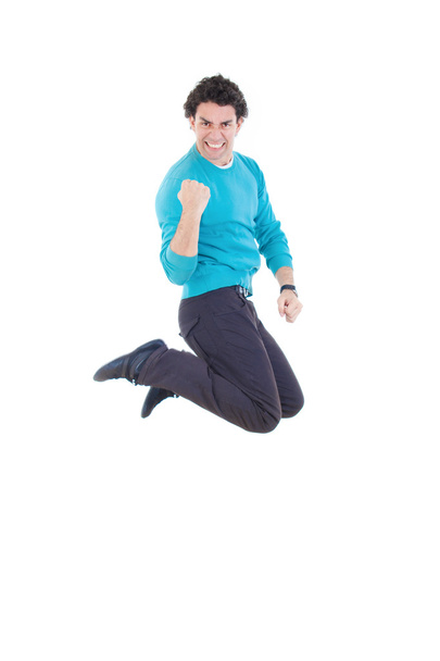επιτυχής νεαρός πηδούν έξω από χαρά, εκφράζοντας την ευτυχία - Φωτογραφία, εικόνα