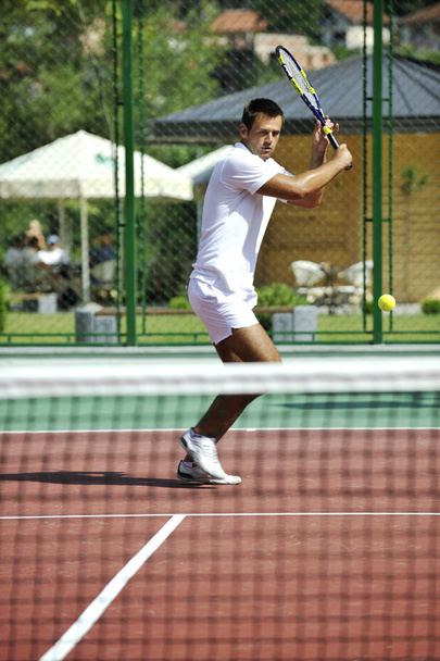 Young man play tennis outdoor - Fotografie, Obrázek
