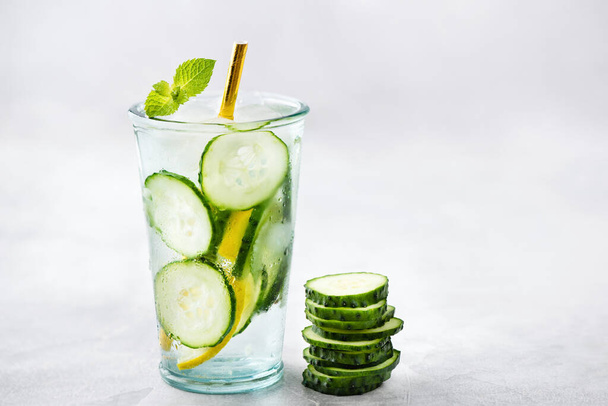 Cucumber detox water isolated on concrete background. Copy space for text - Photo, Image