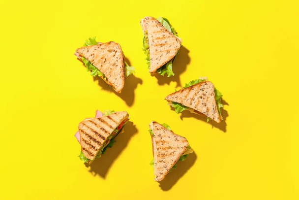 Frame made of tasty sandwiches on color background - Photo, Image