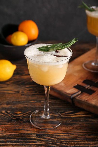 Glass of tasty whiskey sour cocktail on table - Φωτογραφία, εικόνα