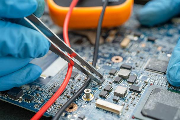 technician repairing inside of hard disk by soldering iron. Integrated Circuit. the concept of data, hardware, technician and technology. - Photo, Image
