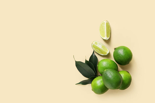 Tasty limes on color background - Φωτογραφία, εικόνα