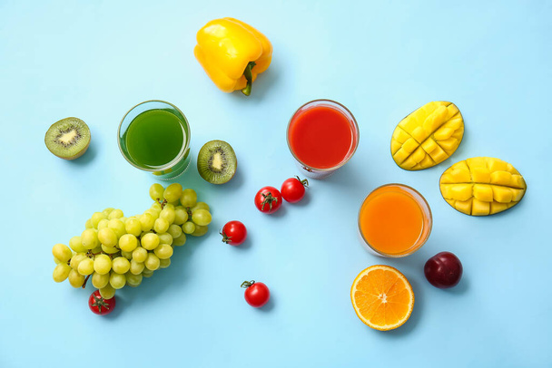 Ποτήρια με υγιεινό χυμό, φρούτα και λαχανικά στο φόντο χρώμα - Φωτογραφία, εικόνα