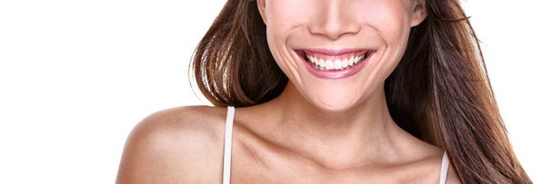 Perfect smile smiling woman with white teeth on white background copy space banner. Closeup of mouth and toothy smile. - 写真・画像