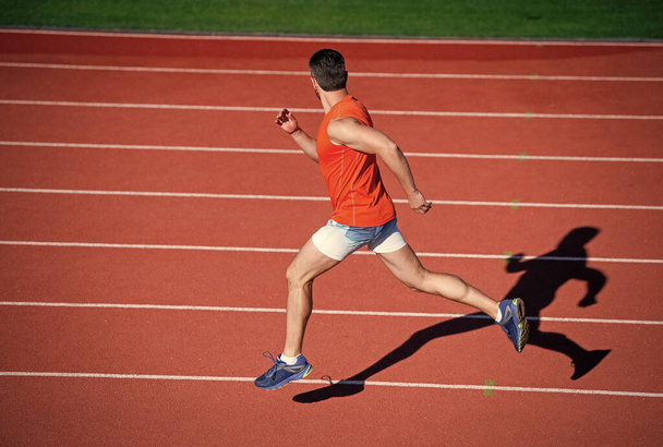 sportsman guy in sportswear run fast sprinting on running track, stamina - Fotoğraf, Görsel
