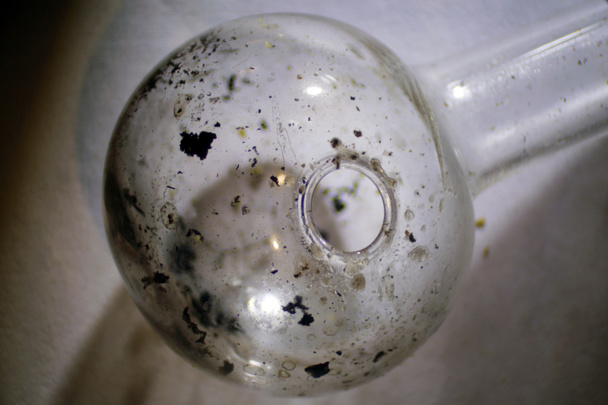 Microscopic Close Up of a Used Methamphetamine Glass Pipe used for Smoking Crystal Meth. Found on a sidewalk. Meth Residue still inside. Drug Abuse. - Foto, Bild