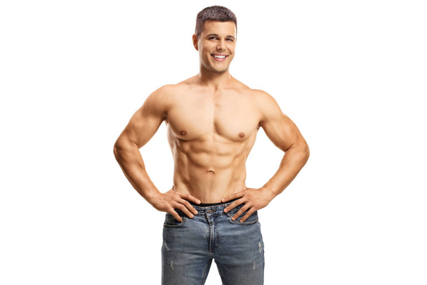 Handsome shirtless muscular guy wearing jeans and posing isolated on white background - Fotó, kép