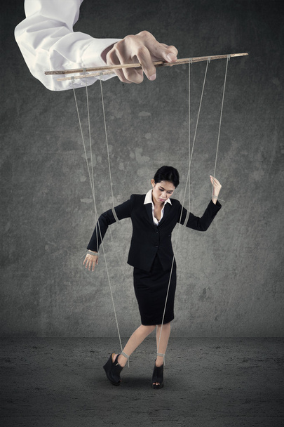 Businesswoman hanging on string - Foto, Bild