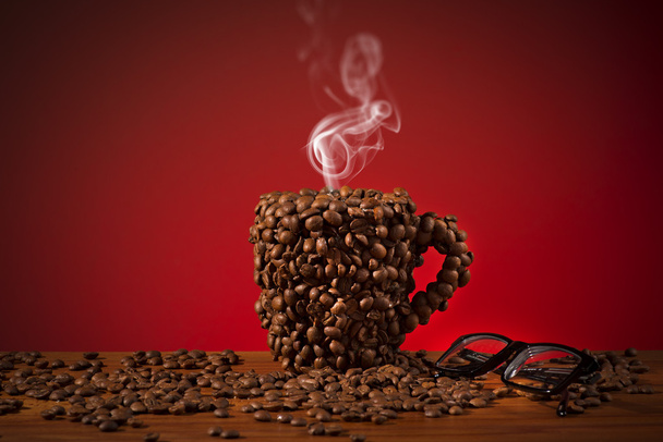 Cup of coffee beans - Фото, изображение