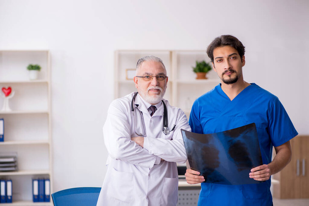 Two male doctors working in the clinic - Photo, Image