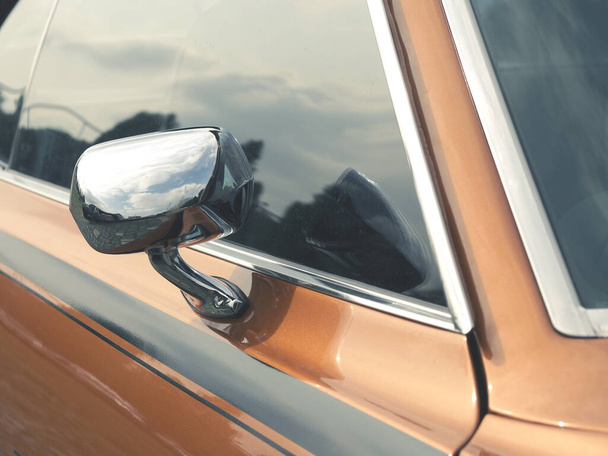 Sideview mirror of an old vintage car, conceptual vintage background with space for text - Fotoğraf, Görsel