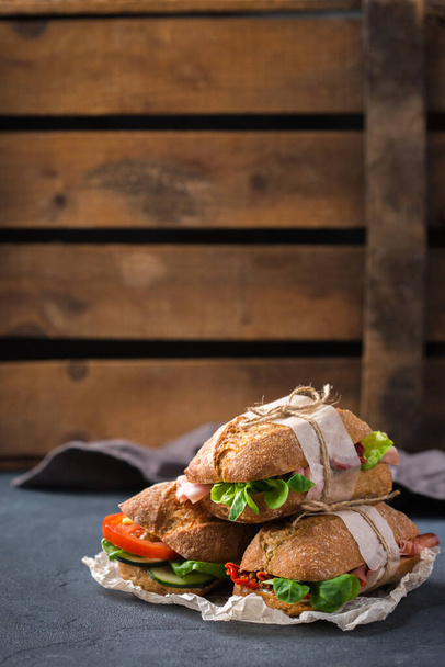 Fresh rye bread sandwich with ham, lettuce and tomato - Fotó, kép