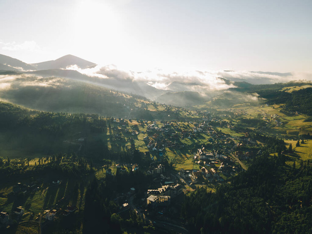 aerial view of sunrise above village in carpathian mountains. copy space - Photo, Image