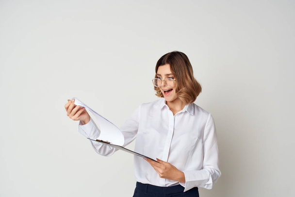 Business woman in white shirt papers emotions light background - Photo, Image