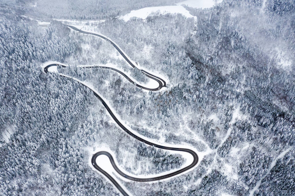 Winter snow winding road Serpentine Switchbacks forest woods season aerial photo view drone - Photo, Image