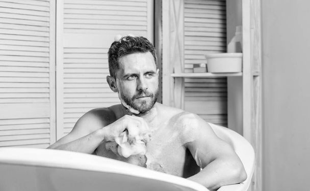 desire and temptation. hygiene and health. Morning shower. man wash muscular body with foam sponge. personal care. Sexy man in bathroom. macho man washing in bath. I love it - Φωτογραφία, εικόνα