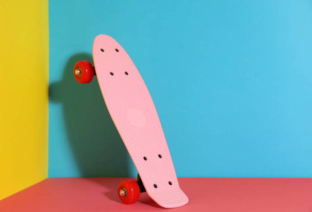 Pink skateboard on color background. Space for text - Zdjęcie, obraz