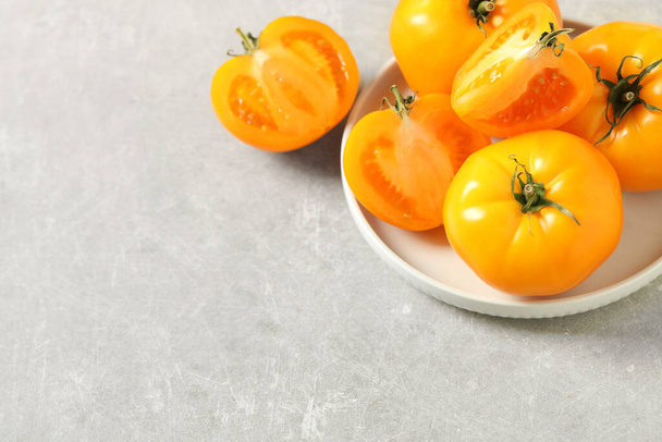 Fresh ripe yellow tomatoes on light table. Space for text - Foto, Imagem