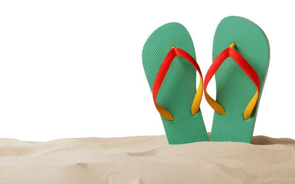 Turquoise flip flops in sand on white background - Photo, image