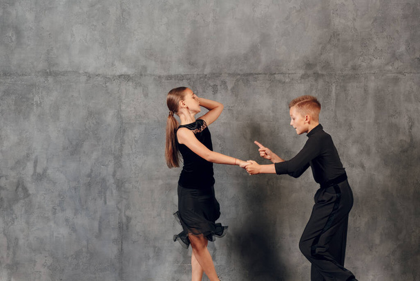 Young boy and girl dancing ballroom dance Jive - 写真・画像