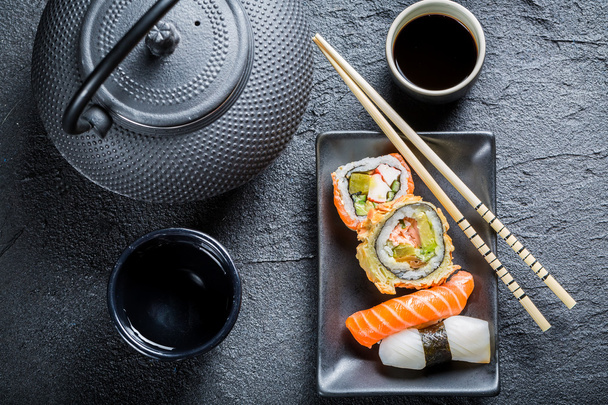 Sushi served with tea - Фото, зображення