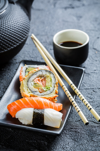 Fresh sushi served in with tea - 写真・画像