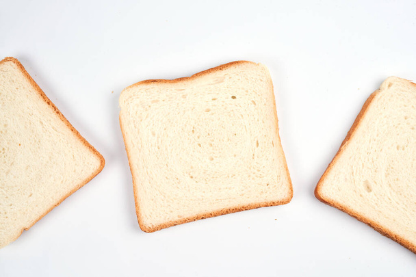 Square slices of toast sandwich bread isolated on white background close up - Φωτογραφία, εικόνα
