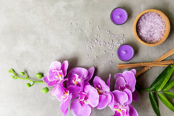 Thai Spa Treatments aroma therapy salt and sugar scrub massage with purple orchid flower on backboard with candle. Thailand. Healthy Concept. - 写真・画像