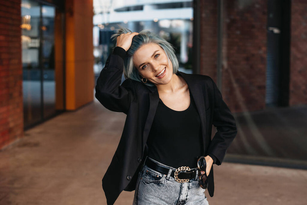 Beautiful portrait of blue haired businesswoman. Pretty young woman. Stylish person posing outside. - Foto, afbeelding