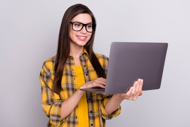 Photo of young business woman happy positive smile look read browse laptop isolated over grey color background - Fotoğraf, Görsel