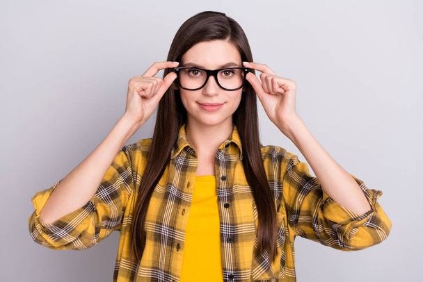 Photo of charming sweet young lady wear plaid shirt arms glasses smiling isolated grey color background - Φωτογραφία, εικόνα