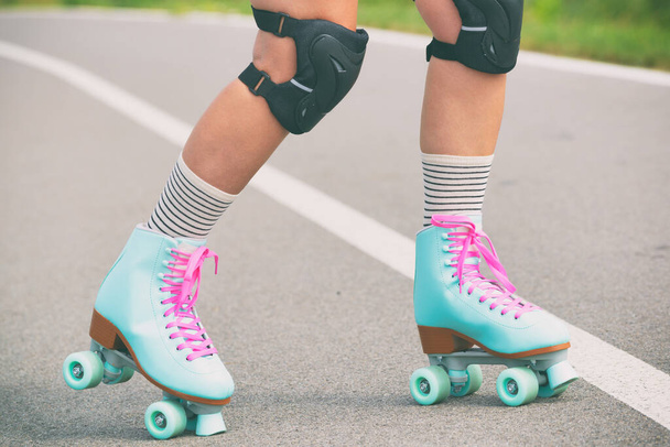 Woman rollerskater wearing knee protector pads on her leg - Photo, Image