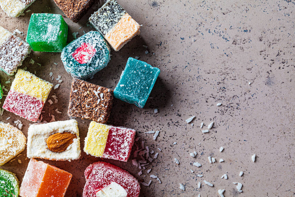 Turkish delight of different types, dark background, top view. - Photo, image
