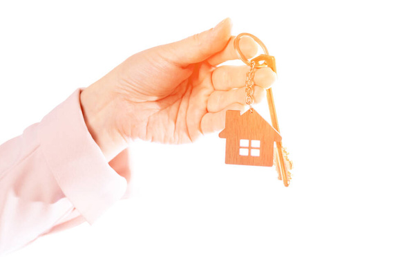 Womans hand holds the key to the apartment, isolate on a white background - Фото, зображення