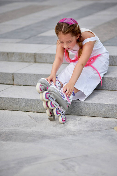 cute little girl on roller skates at park. - Valokuva, kuva