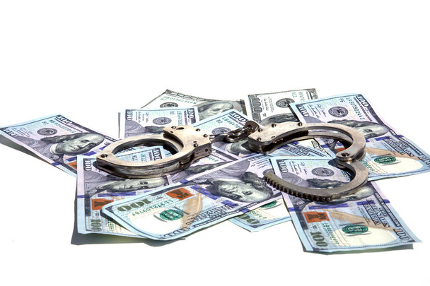 Money with Handcuffs. American Money Locked up with Hand Cuffs. Isolated on white. Room for text. Financial and Banking Concepts. Money or savings locked up for the future concepts. - Photo, image