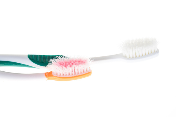 Two Color worn toothbrush on isolated white background - Photo, Image