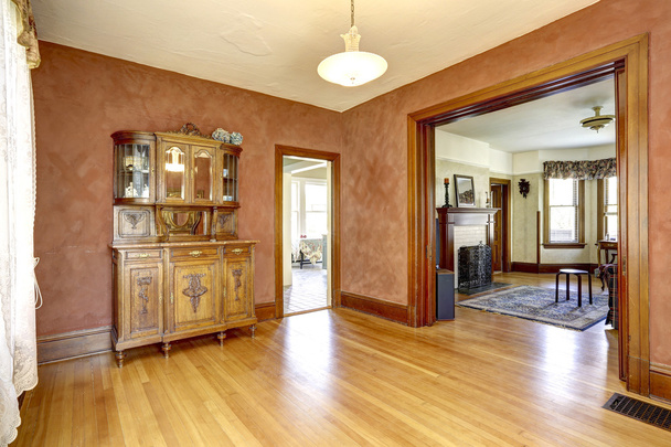 Empty room in bright red color with antique cabinet - Photo, Image