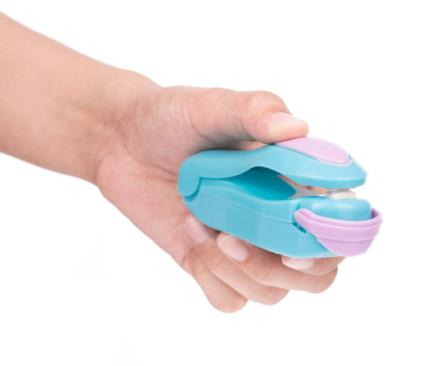 Hand holding Blue plastic food sealer isolated on white background. - Photo, Image