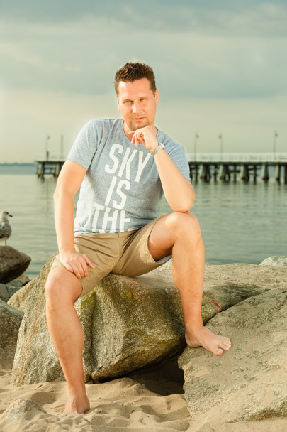 Fashion portrait of handsome man on the beach - Photo, Image