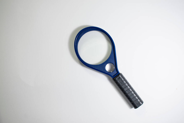 A closeup of a magnifier on white background. - Фото, зображення
