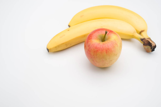fresh and healthy fruits on a white surface - apple and banana - Foto, afbeelding