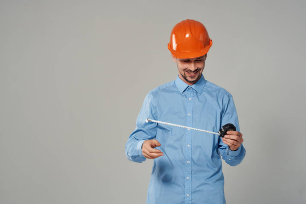man in orange helmet blueprints builder isolated background - Foto, afbeelding