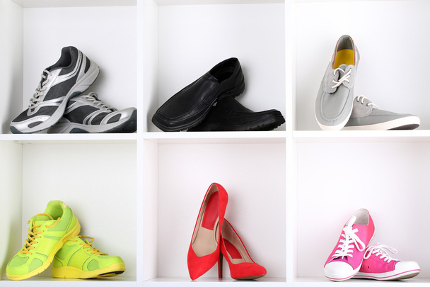 Colorful shoes on wooden shelves - Fotó, kép